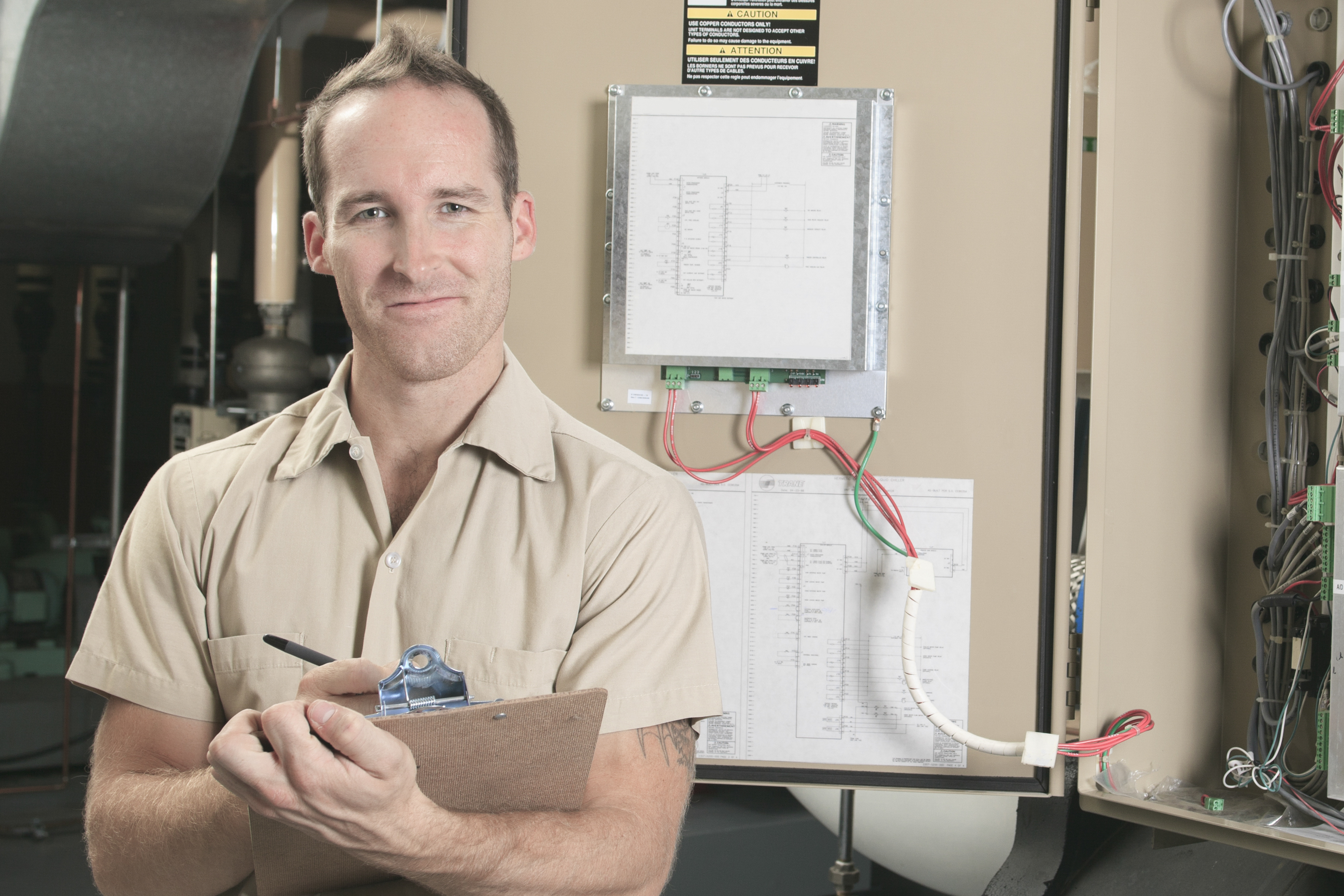 A technician holding a clipboard in Andover